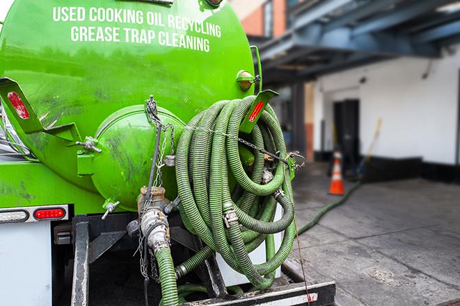 a professional technician pumping a restaurant's grease trap in Agoura Hills, CA